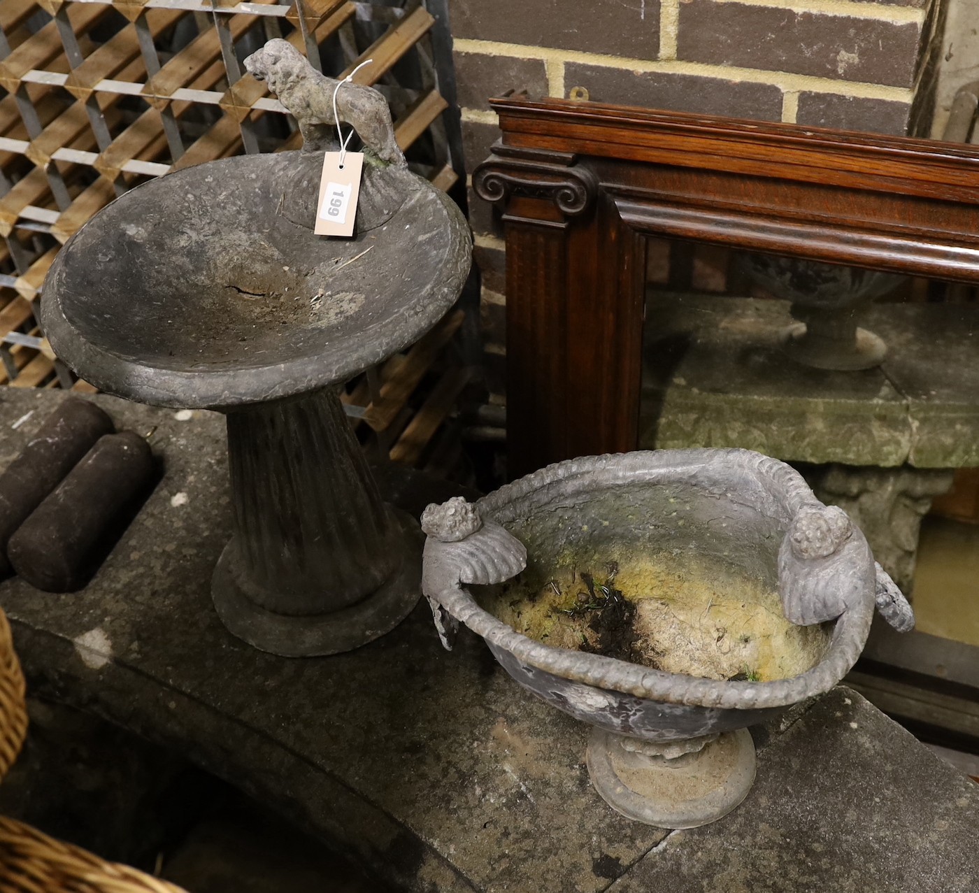 A lead garden bird bath with lion surmount, height 44cm together with a lead planter